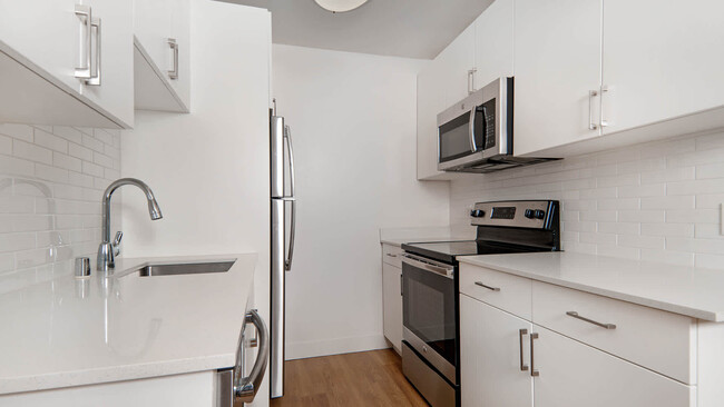 Kitchen with Stainless Steel Appliances and Quartz Countertops - Arbor Terrace