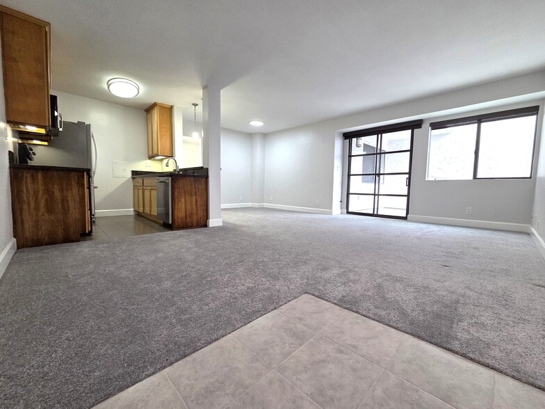 Living room and dining area. Glass doors to balcony. - 10982 Roebling Ave