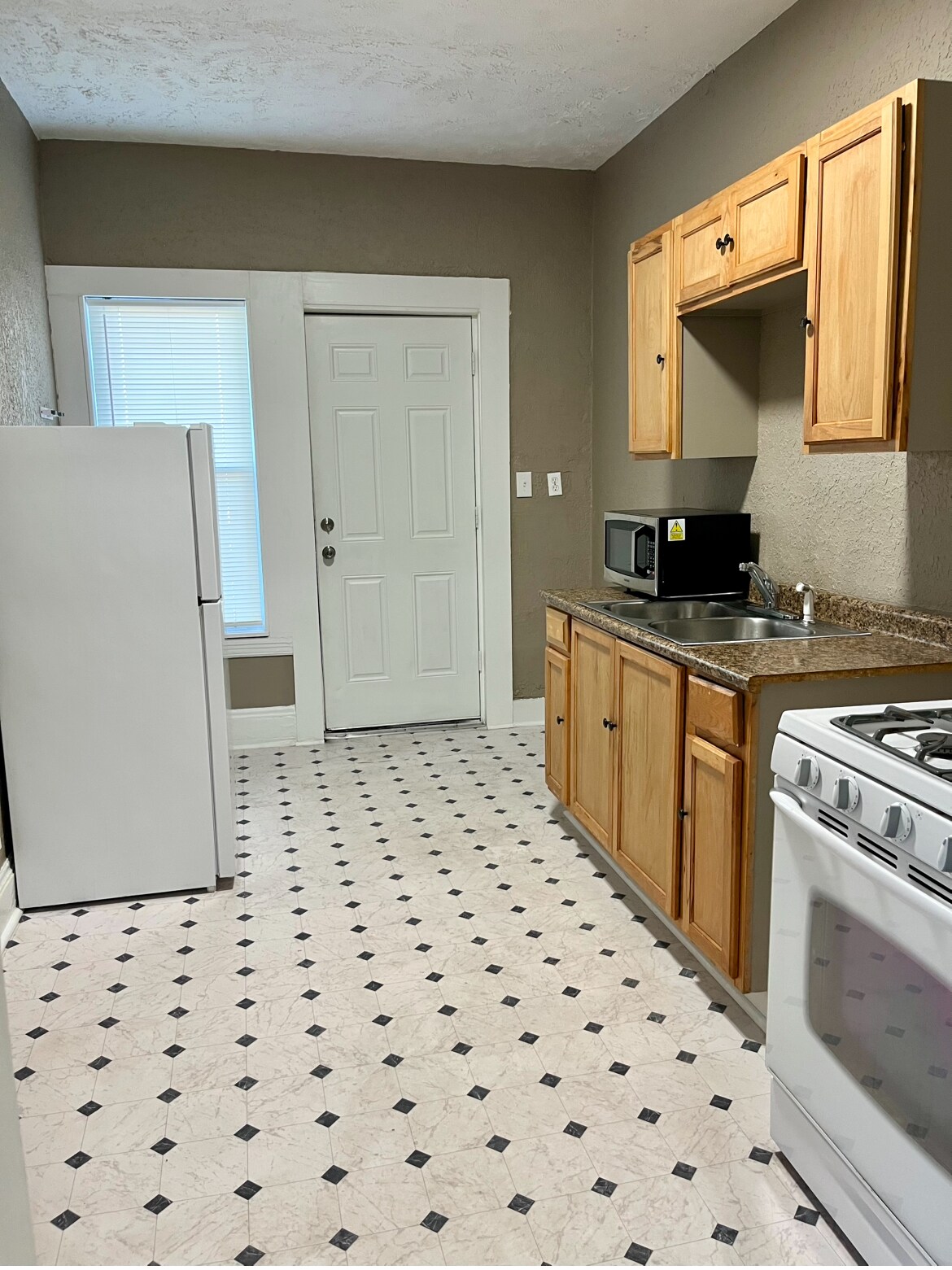Kitchen: Includes a stove and refrigerator; microwave available for a small rental fee. Durable viny - 603 E 109th St