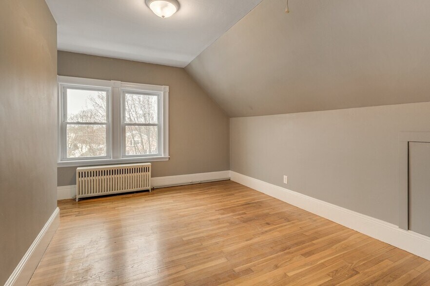 Spacious main bedroom with large windows and closet. - 5 Larchmont Rd
