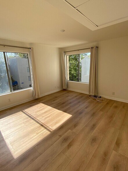 Spacious primary bedroom with abundant natural light - 8305 Summertime Ln