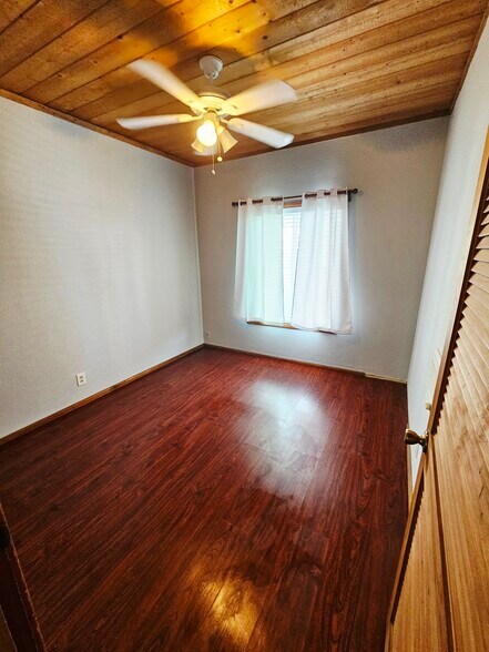 Bedroom with wood laminate flooring. - 934 S Myers St