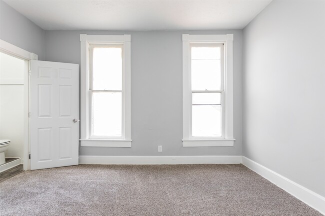 Upstairs bedroom with attached half bath. - 1150 Tecumseh St