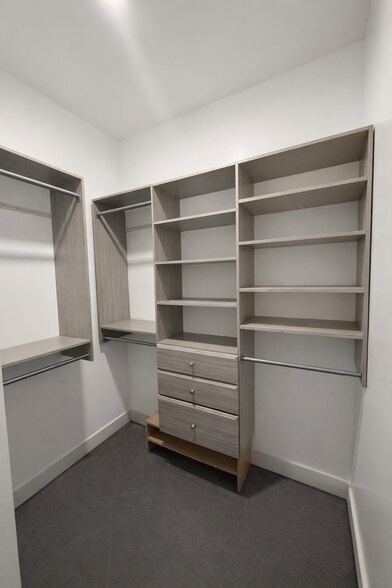 Primary walk-in closet with custom built-ins - 1733 NW 63rd St