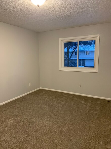 One of the two bedrooms upstairs, one features a walk in closet. - 6224 Magnolia Ln N