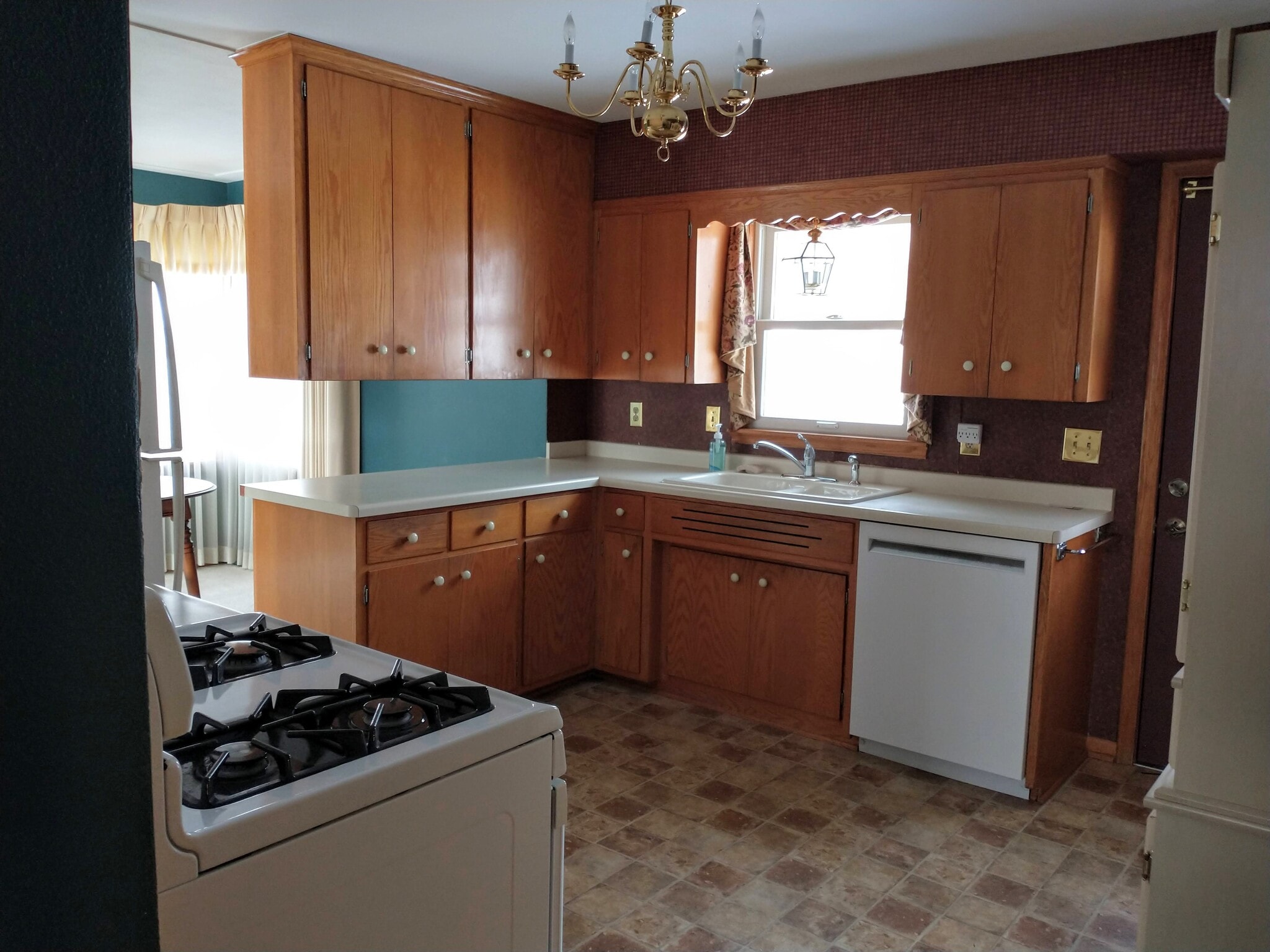Kitchen - nice tall cupboards - stove is gas - planning to update lighting, handles, switches and outlets - 2163 Randy Ave