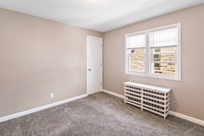 Building Photo - This spacious upper unit features 2 comfortable bedrooms with carpeting