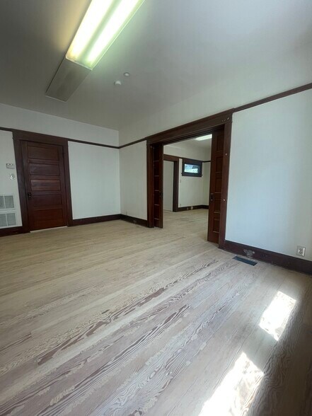 Second large bedroom with hardwood floors adjacent to a large, completely renovated full bathroom. - 1135 Magnolia St