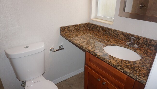 Building Photo - Four Bed - Three Bath - Large Storage Area...