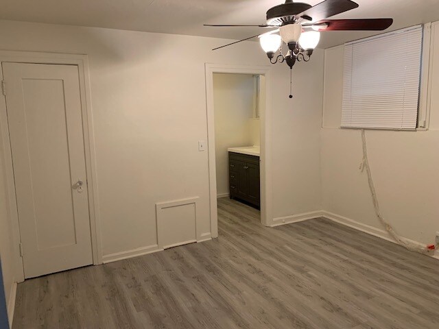 View of the main, larger bedroom with closet door to the left and bathroom to the right. - 24606 University Ave