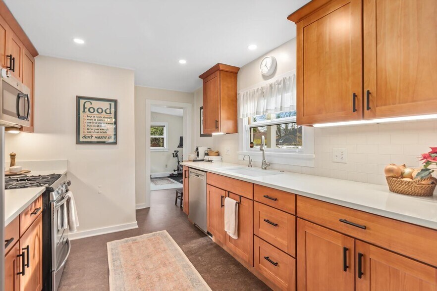 Updated kitchen with stainless steel appliances, gas range, instant-hot water - 8042 Earl Ave NW