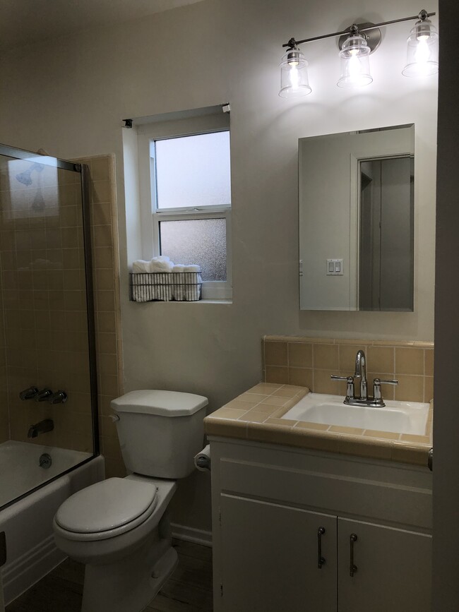 Window in bathroom with new fixtures - 3856 W 242nd St