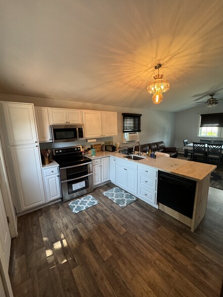 Kitchen with granite countertops and butcher block counter. - 21 Wallis Ave