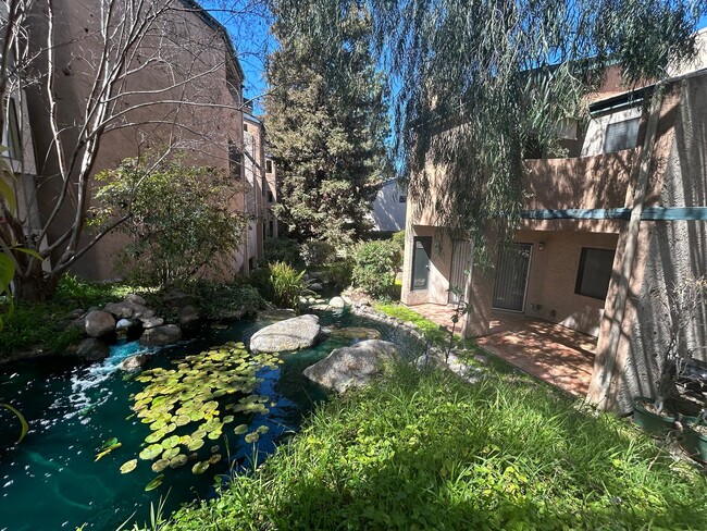 Building Photo - One Bedroom with Garage and IN-Unit laundry in Resort-Style Complex