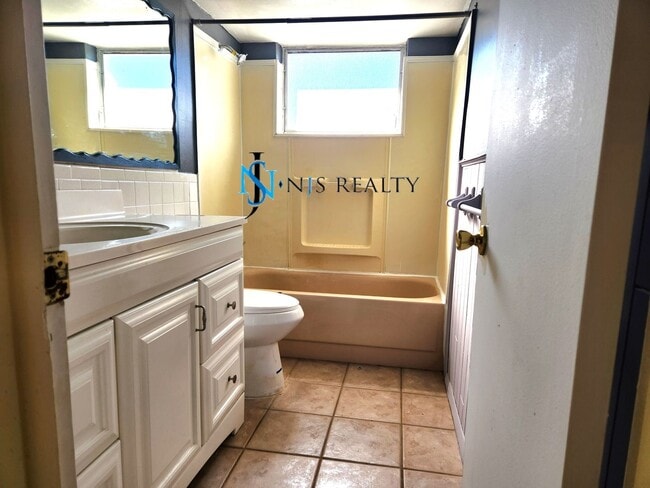 Building Photo - JUST REDUCED!!! True 2/1.5/1 with FIREPLACE, fenced yard and all tile flooring throughout!