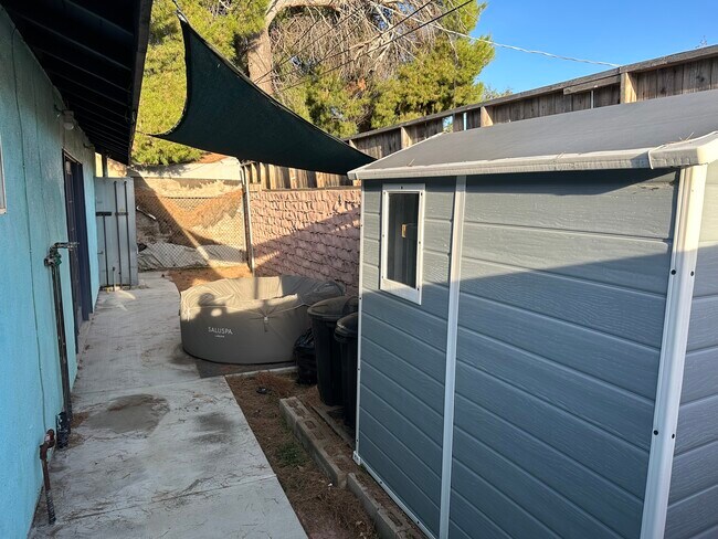 Back patio with storage sheds - 12020 Neenach St