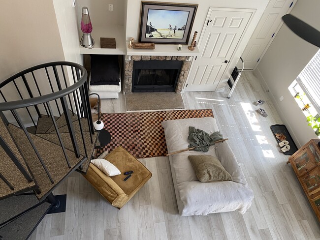 living room/fireplace/front door from loft - 8341 S Upham Way