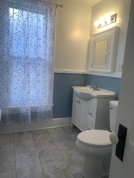 Brand new flooring, vanity, and paint in the bathroom - beautiful! - 2645 Colfax Ave S