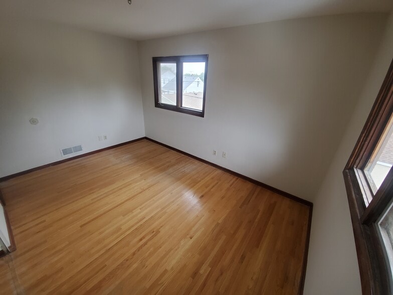 Bedroom #2 Hardwood floors 2 windows great for natural sunlight and cross breeze - 1182 Lane Pl