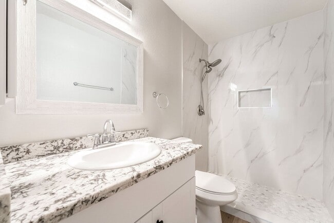 Building Photo - Upgraded Three-Bedroom Condo with Wood Flooring and Modern Comforts!