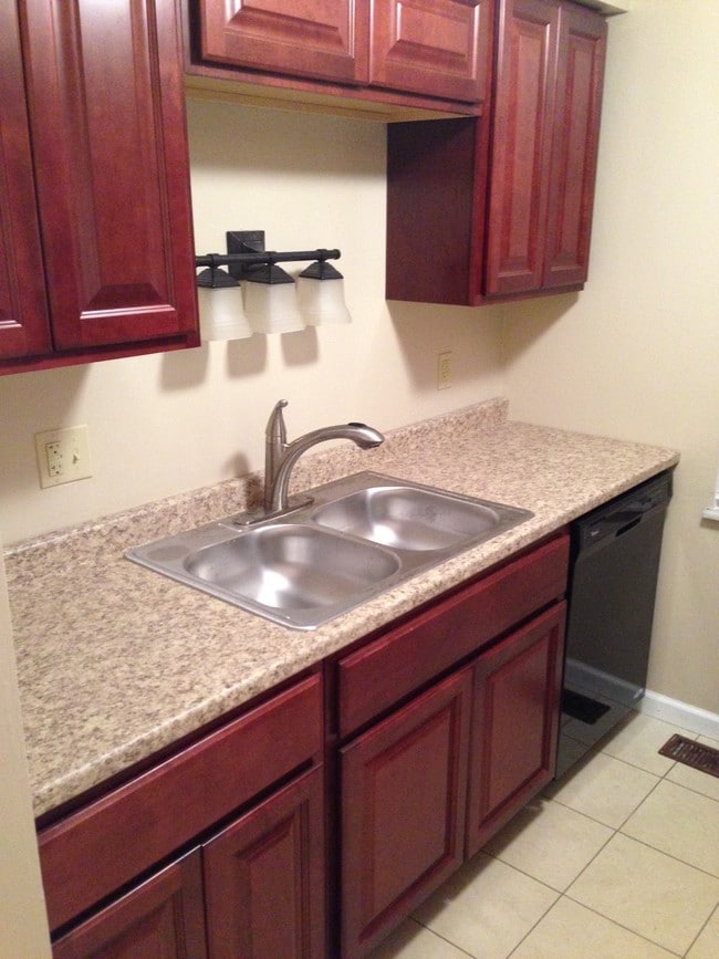 Kitchen with dishwasher, refrigerator and stove - 246 E Commons Dr