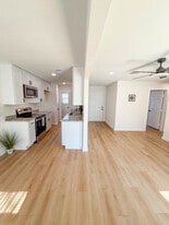 Kitchen with stainless steel appliances leading to separate laundry room. Open floor plan from dinin - 308 E Bourn St