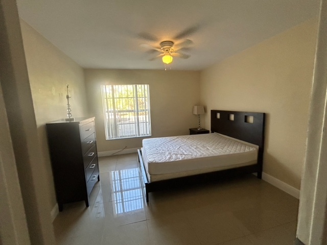 furnished room with queen bed and dresser - 490 NW 20th St