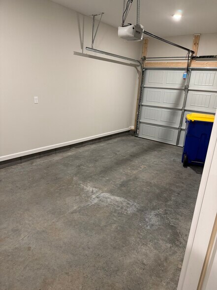 Private attached garage with room for parking and storage—a bonus for convenience and security - 205 Cherry Way