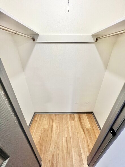 Experience the luxury of a spacious walk-in closet, perfect for organizing your wardrobe. - Melody Apartments