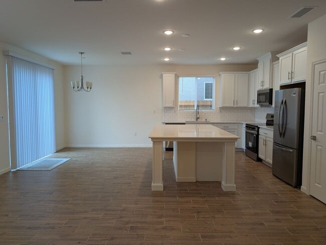 Building Photo - New Wilson home offering modern amenities, solar and a nice floor plan. Bonus room with den or of...