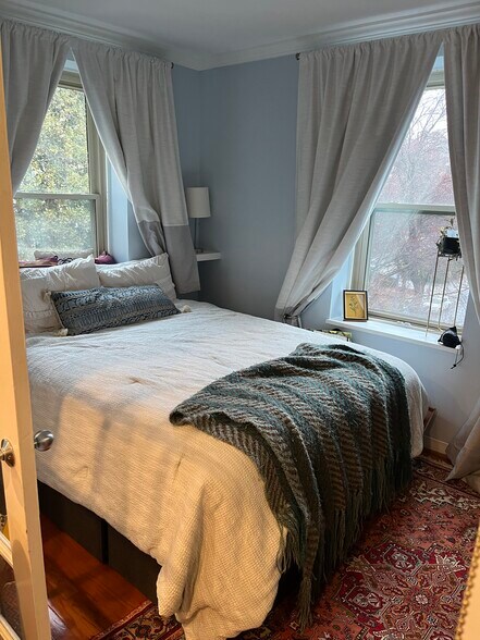 Sunny corner bedroom with custom-fit curtains. - 2440 16th St NW