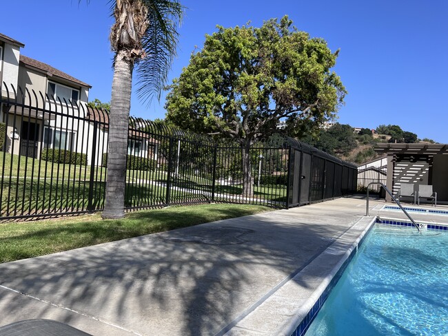 Tropical resort style pool with seating and lounge chairs - 2356 Canyon Park Dr