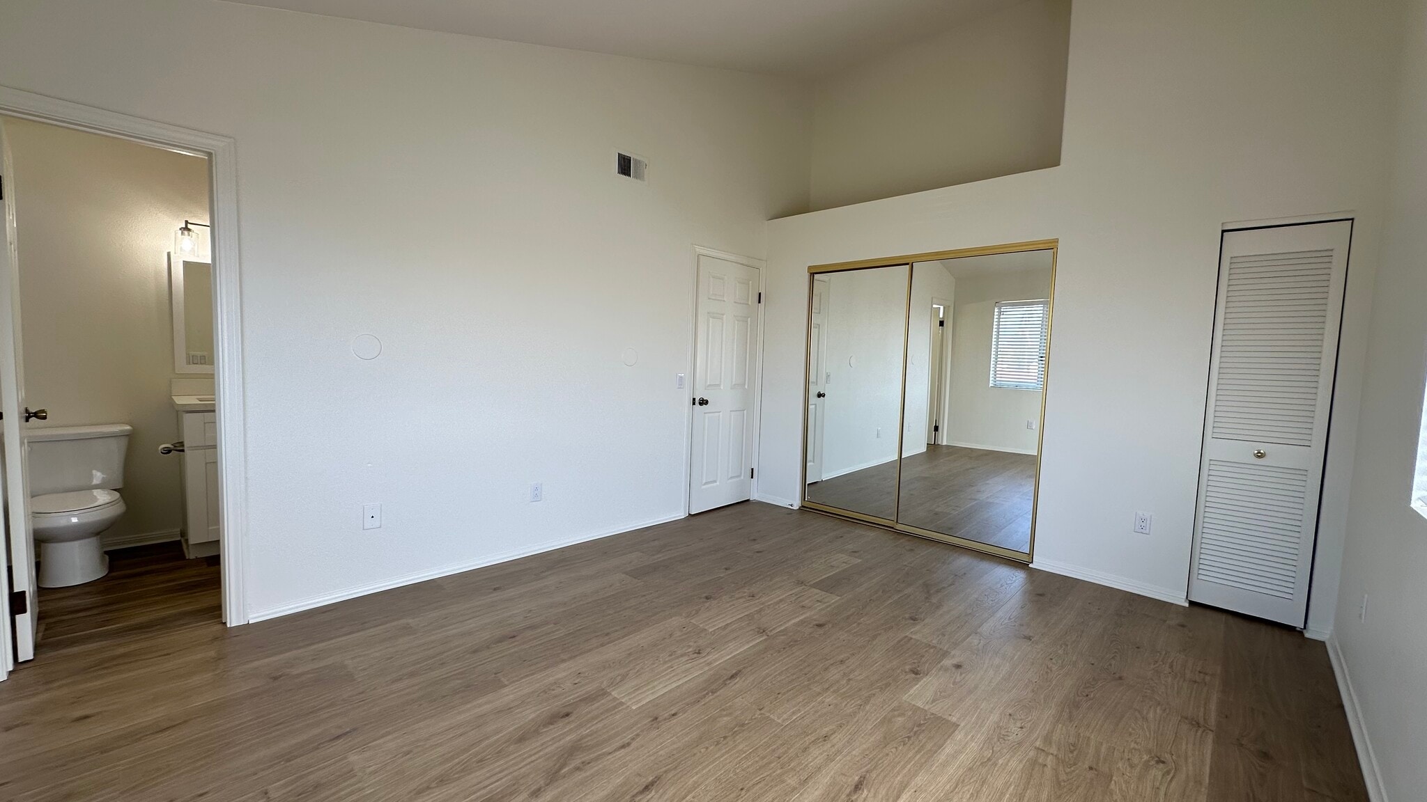 Master bedroom has vaulted ceilings, a main closet, and a smaller extra closet. - 939 Sapphire St