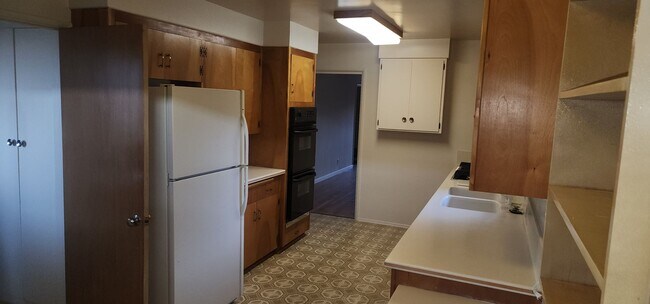 Building Photo - This is a spacious house featuring four bedrooms and two bathrooms, along with a two-car garage.