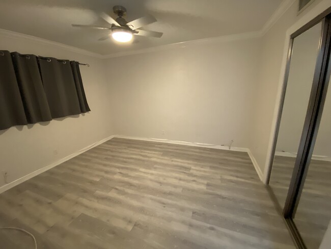 New soft grey LVP flooring in bedroom - 1012 SE 15th St