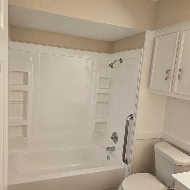 Building Photo - Three bedroom and two bathroom nicely remodeled with new flooring. Large wood fenced backyard