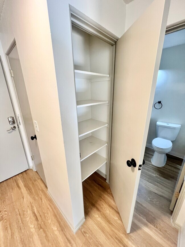 Experience the convenience of ample storage and a sleek bathroom layout. - Harmony Apartments