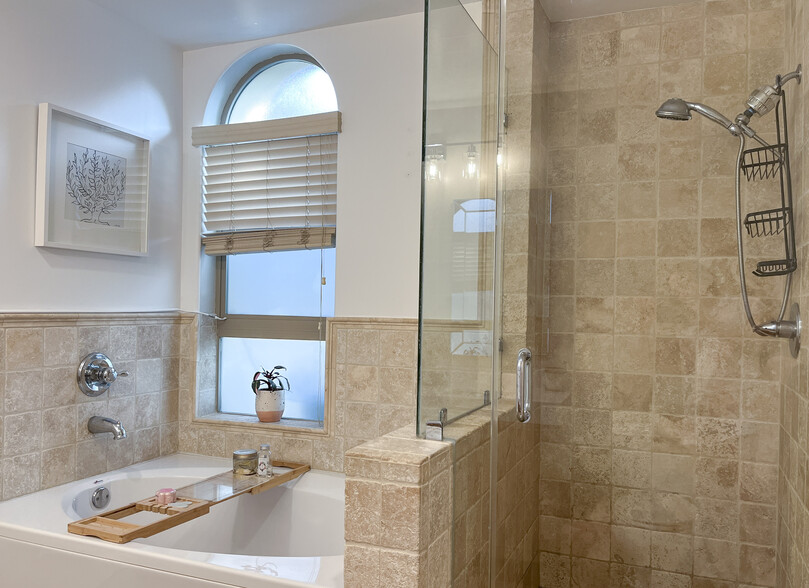 natural stone bathroom with separate walk-in shower - 5037 Rosewood Ave