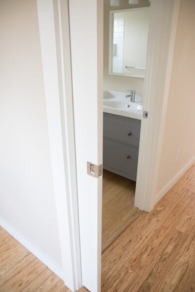 Pocket door divides the bedroom from the hallway with bathroom beyond. - 5239 NE Mason St