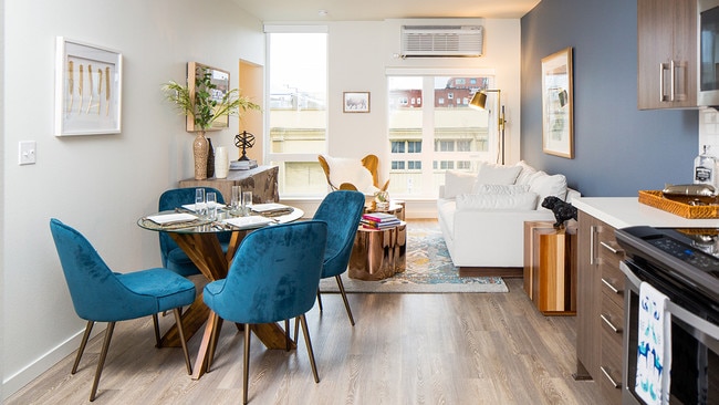 Open-concept living space with dining area and stylish kitchen. - Modera Belmont