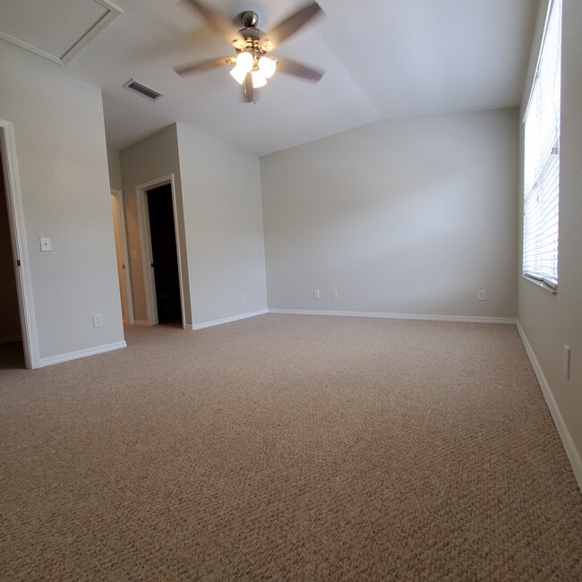 Spacious primary bedroom with ensuite bathroom - 5808 Fishhawk Ridge Dr