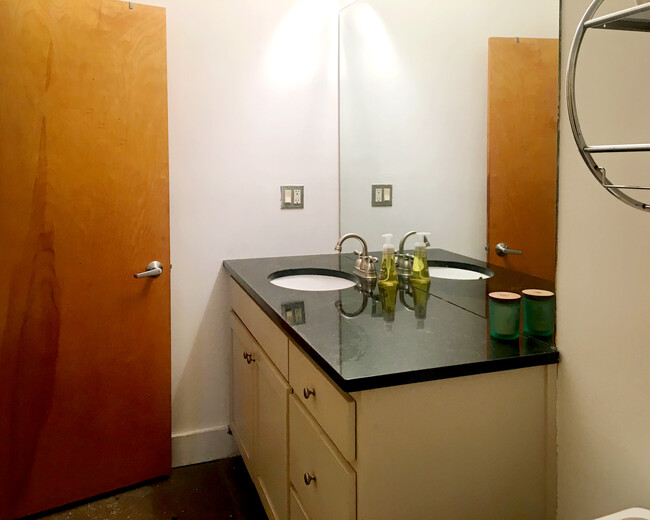 Bathroom with large granite vanity and plenty of storage. - 659 Auburn Ave NE #145