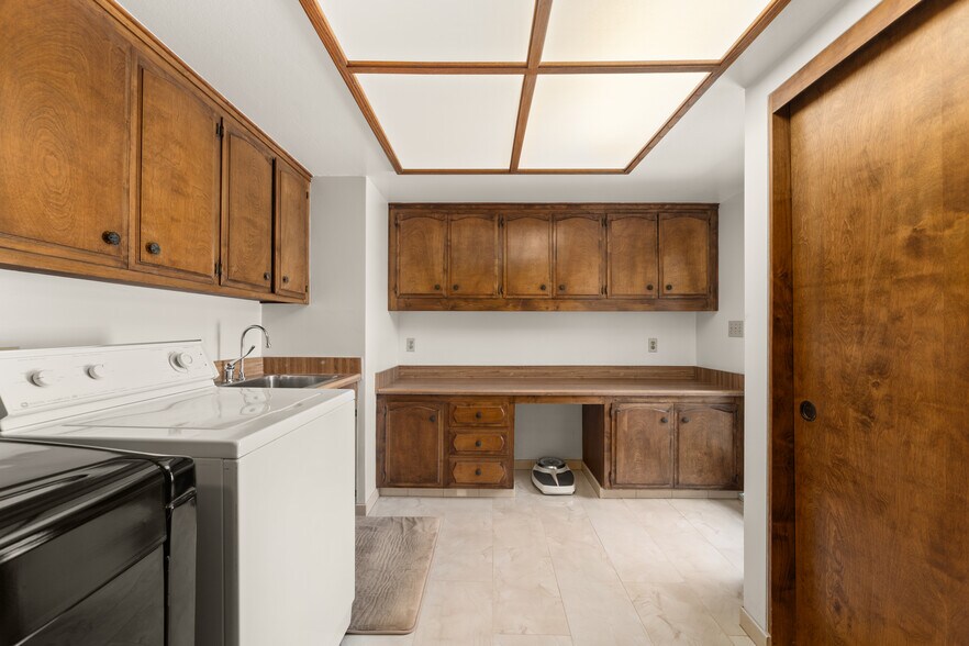 Large Laundry room with full cabinets storage & marble floor Large Sink, Electrical Iron board - 1557 E Puente St