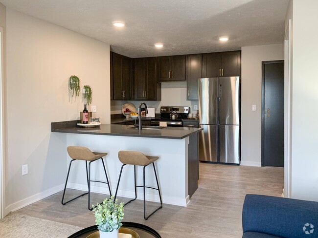 Open-concept layouts connect the kitchen and living areas, providing a seamless space to gather. - The Knock Apartments