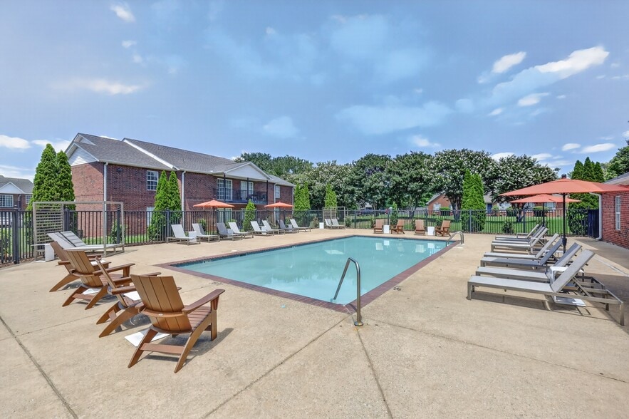 Community swimming pool with an expansive sundeck designed for recreation and relaxation. - Saddlebrook Apartments