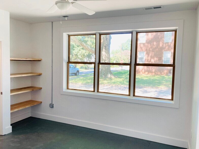 Custom Hardwood Built In Shelving in Primary EnSuite Bedroom beside Triple Windows - 1311 Blair St