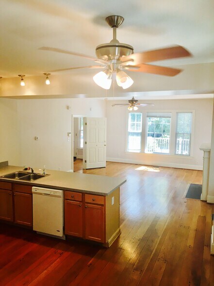 Kitchen with modern appliances, natural light, and open flow to dining and living. - 1937 Fairfield Dr