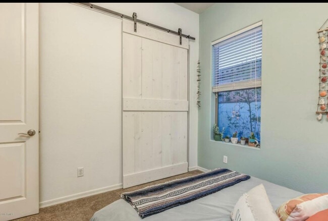 Barn door in guest bedroom - 20892 W Eastview Way