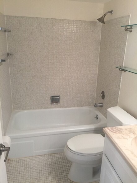 Master bathroom features tub and shower combo and lots of storage with newer vanity, fixtures, lighting and recessed medicine cabinet. Your spa awaits! - 91 Berkshire D