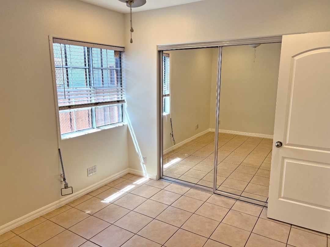 4th bedroom with standard mirrored closet and ceiling fan. - 2330 S Mansfield Ave